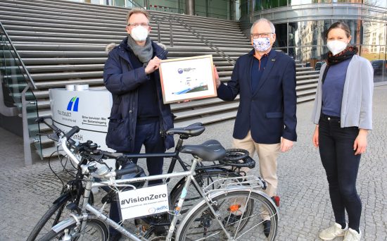 Eberhard Brodhage vom ADFC und Auditorin Carolin Kruse überreichen Toll Collect-Chef Gerhard Schulz das Zertifikat "Fahrradfreundlicher Arbeitgeber".